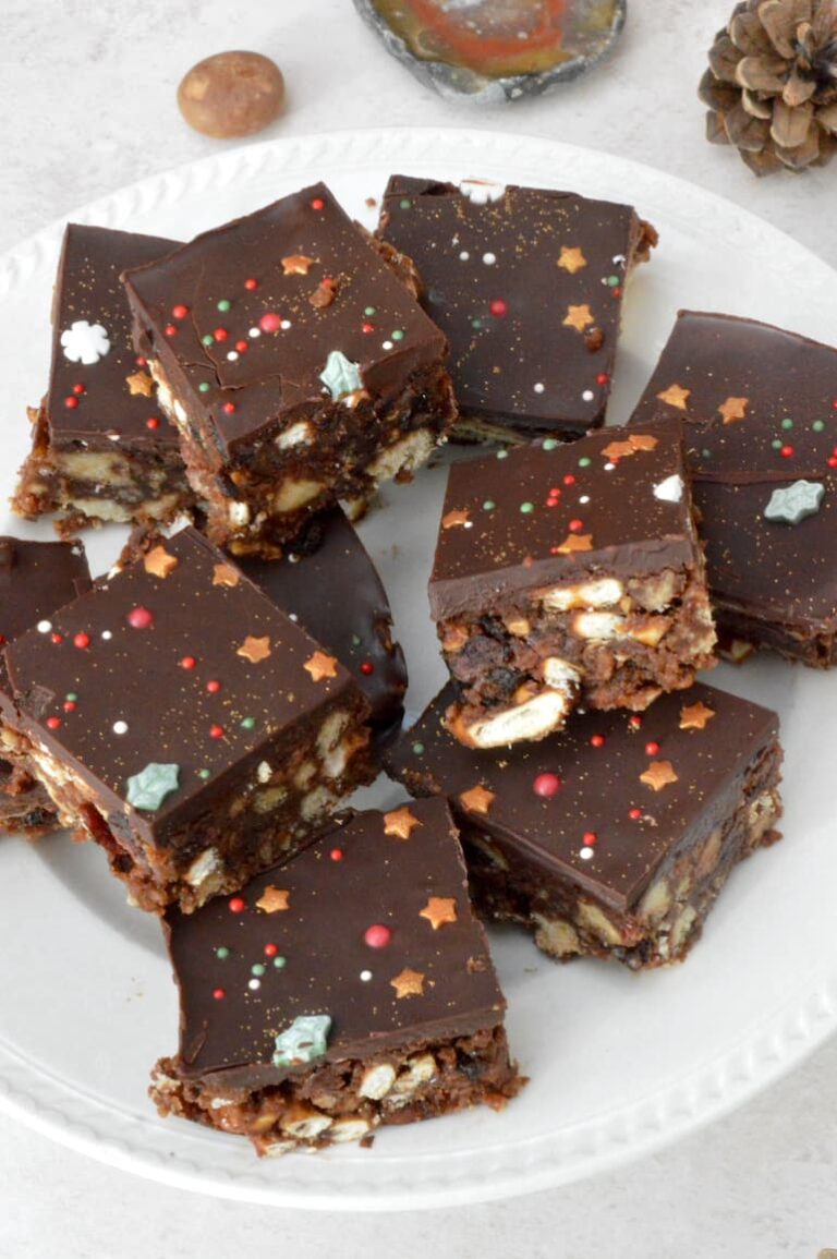Squares of Christmas tiffin piled on a plate.
