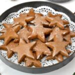 Homemade lebkuchen stars piled on platter.