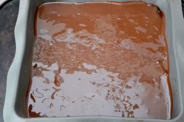 Melted chocolate covering tiffin mix.