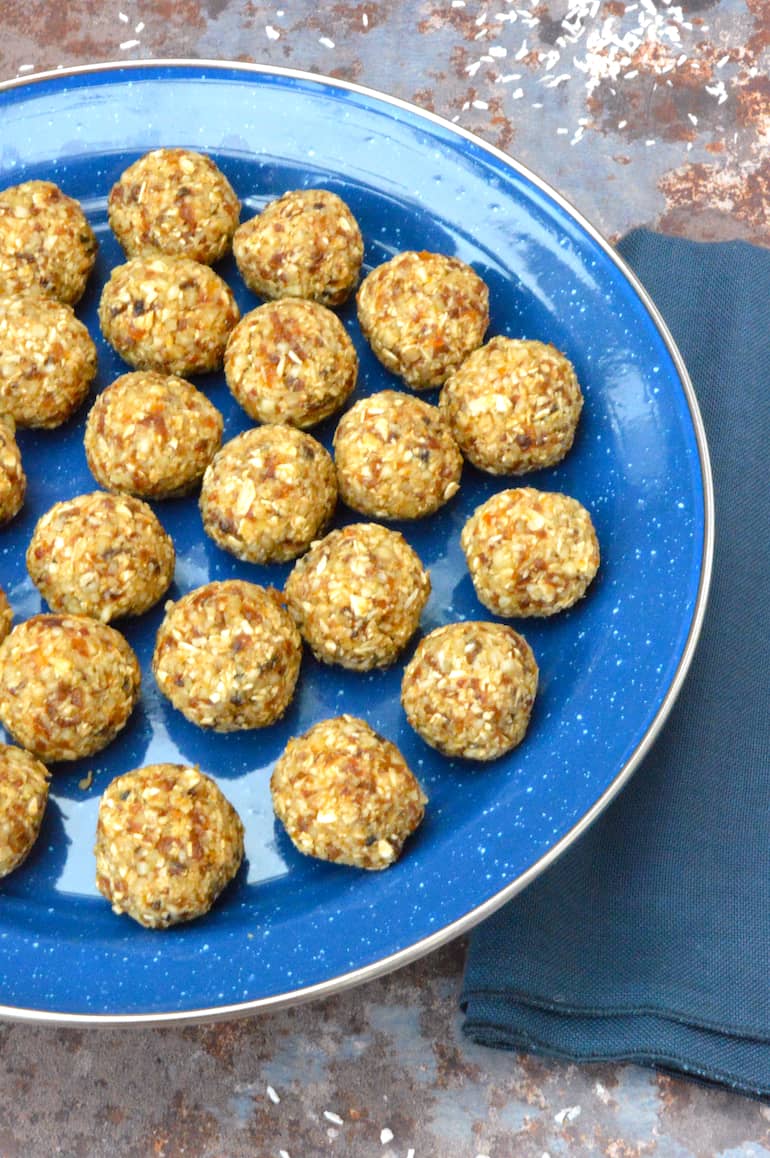 Partial view of a plate of homemade apricot and coconut energy balls.