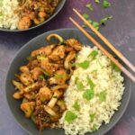 Bang bang cauliflower and brown rice in two bowls.
