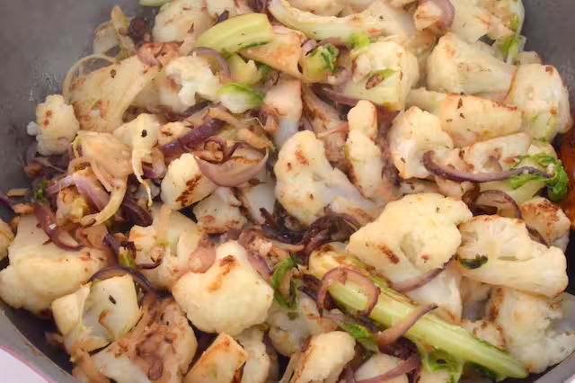 Cauliflower florets cooking and slightly charred.