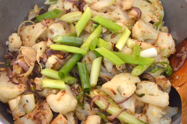 Spring onion batons added to cauli stir-fry.