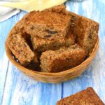 Basket of tahini date flapjacks. A bite out of one on the side.