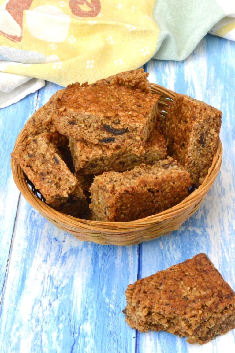 Basket of tahini date flapjacks. A bite out of one on the side.