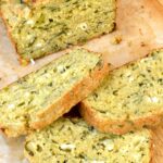 Homemade cottage cheese loaf with wild garlic, partially sliced.