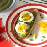 Nettle dip on slice of toast topped by egg slices and chopped chives.
