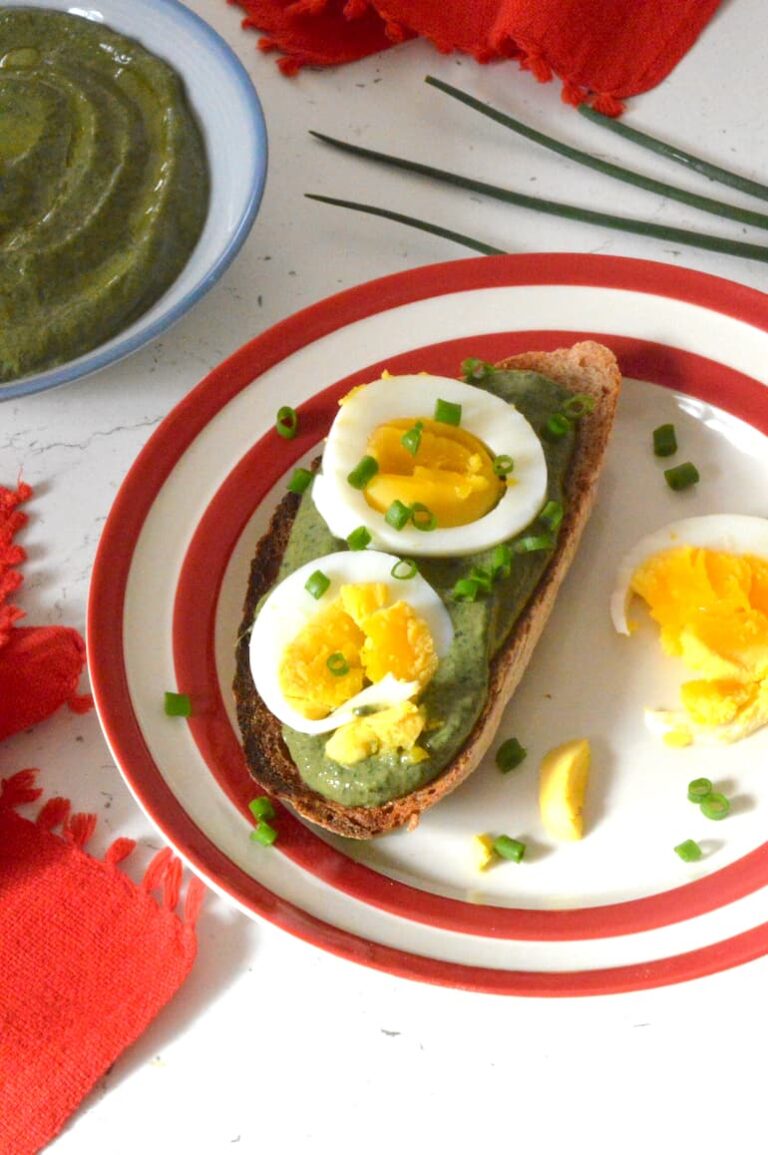 Nettle dip on slice of toast topped by egg slices and chopped chives.