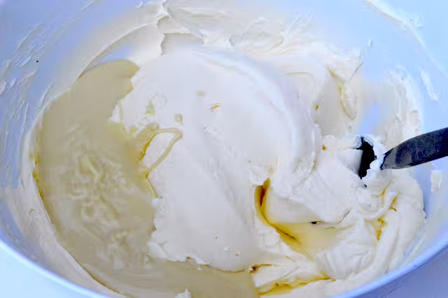 Melted white chocolate added to cream cheese bowl.