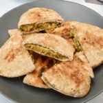 Vegan arayes, made with wholemeal pitta pockets, piled up on a plate