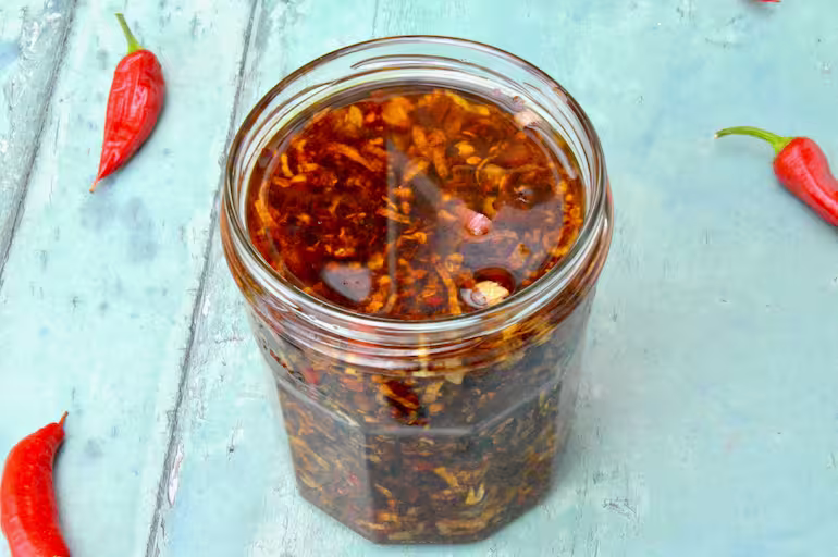 Homemade crispy chilli oil in jar.