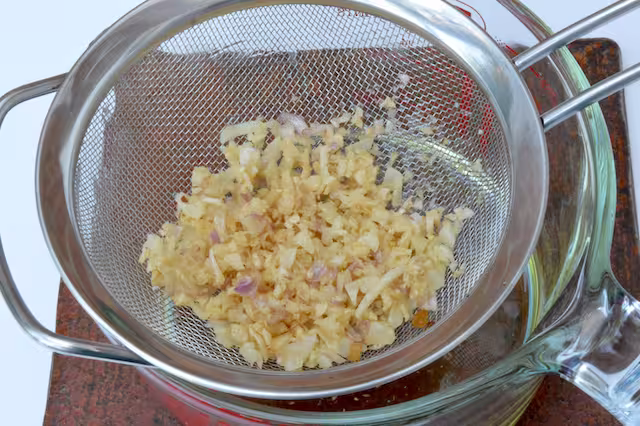 Fried garlic draining in seive.
