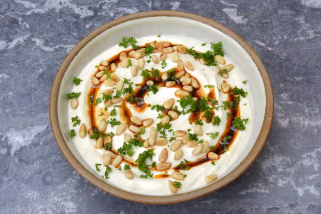 All the toppings - warm spiced olive oil, toasted pine nuts and chopped parsley.