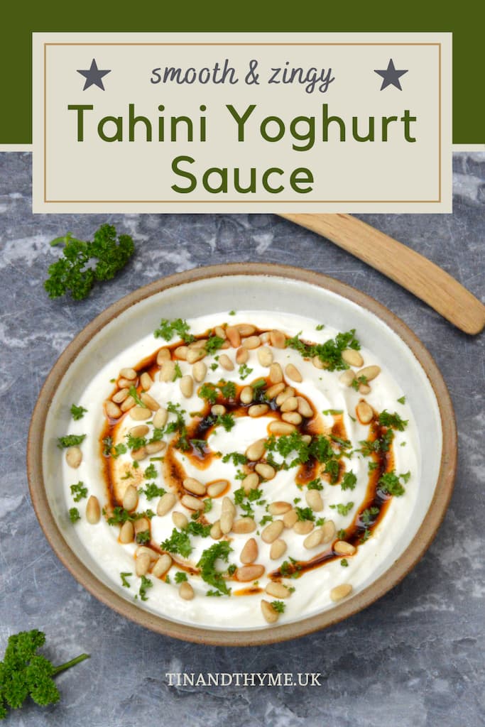 Pin showing bowl of tahini yoghurt sauce topped with paprika oil, pine nuts and parsley.