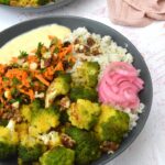 Partial view of two roasted romanesco buddha bowls.