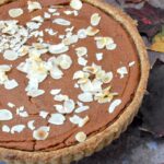 Medlar tart made with wholemeal pastry and topped with flaked almonds.
