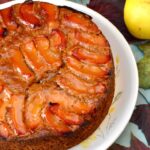 Quince cake decorated with syrupy slices. Autumn leaves and 3 quinces.