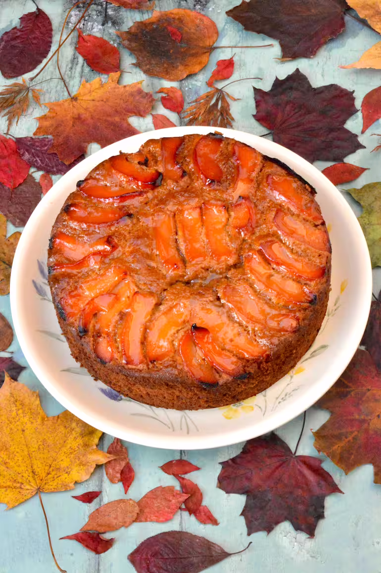 Homemade fragrant, autumn coloured quince cake on plate.