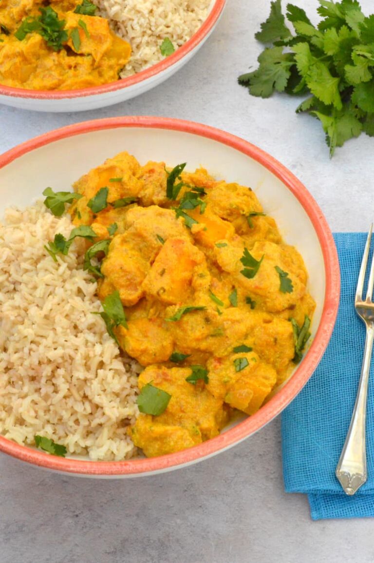 Bowl of protein-rich creamy vegan squash curry with rice.