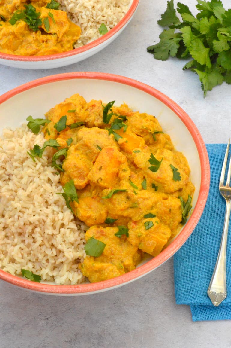 Bowl of protein-rich creamy vegan squash curry with rice.