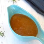 Homemade vegetarian gravy in turquoise gravy boat.