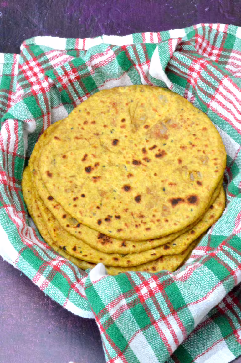 Stack of vegan keema paratha in cloth lined basket.