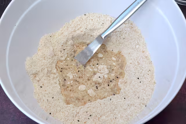 Water added to flour mix in bowl with knife.