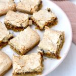 Homemade easy jam coconut slice pieces on cake stand.