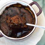 Spoonful of sponge being removed from vegan chocolate self-saucing pudding.