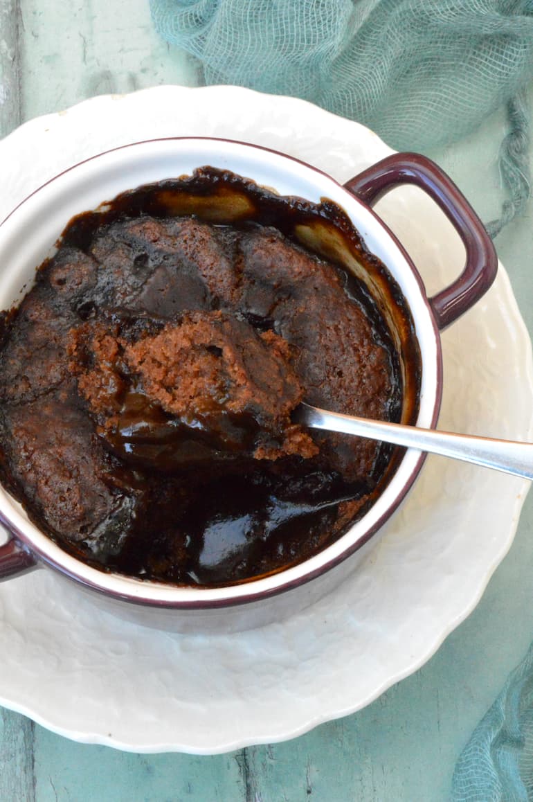 Spoonful of sponge being removed from vegan chocolate self-saucing pudding.