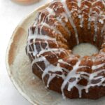 Partial view of wholemeal apple juice cake drizzled with apple juice icing.