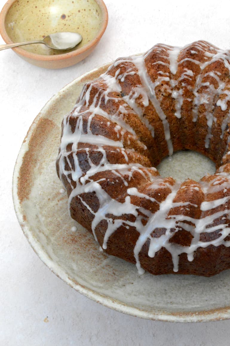 Partial view of wholemeal apple juice cake drizzled with apple juice icing.