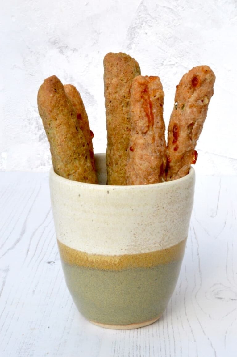 Easy no yeast spelt breadsticks in ceramic beaker.