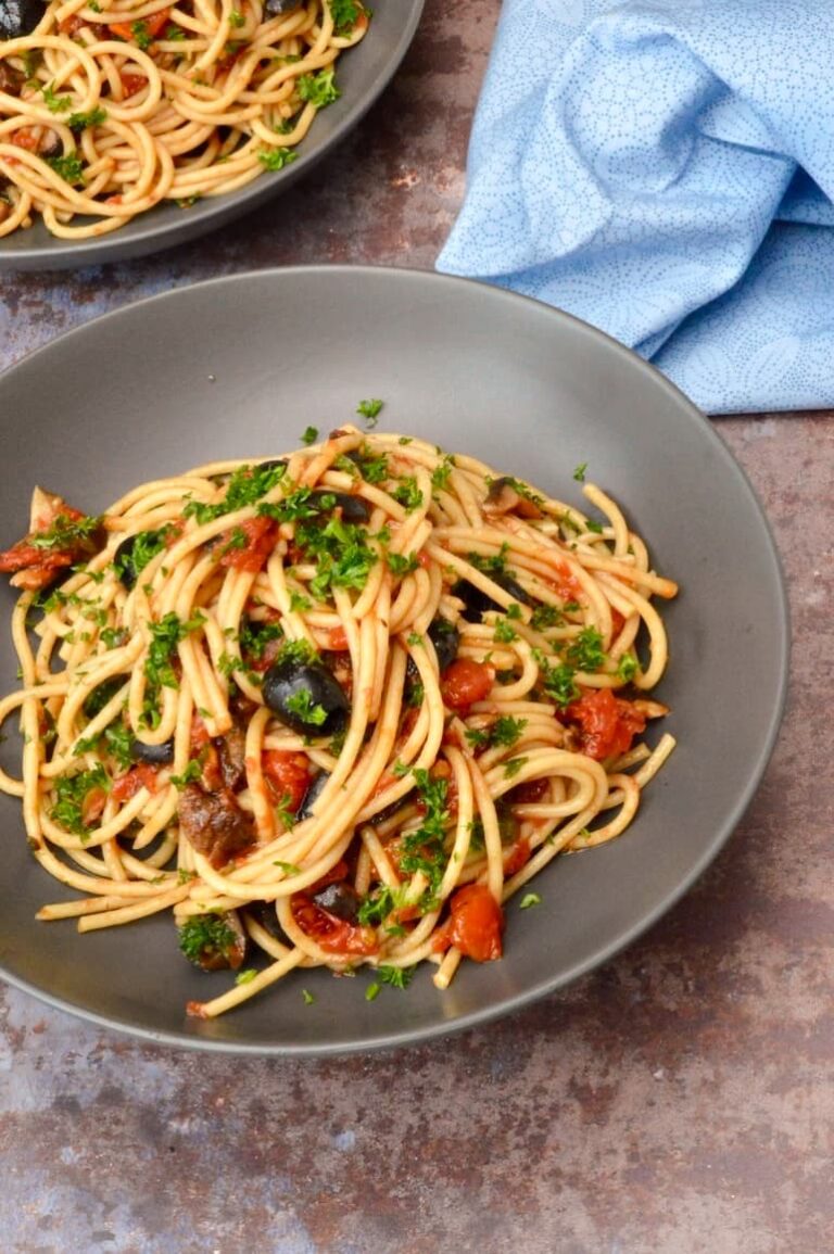 Bowl of homemade vegan pasta alla puttanesca.