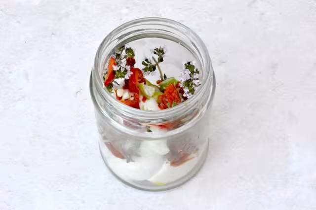 Jar half filled with nodini and aromatics.