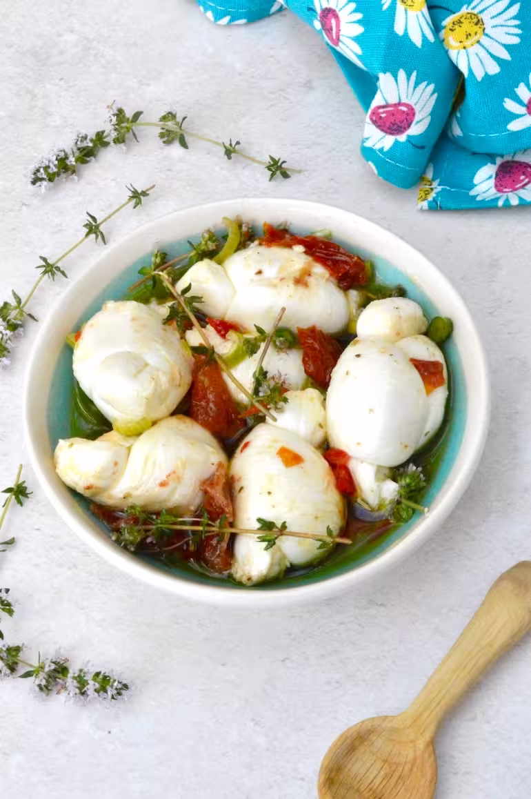 Bowl of marinated mozzarella balls.