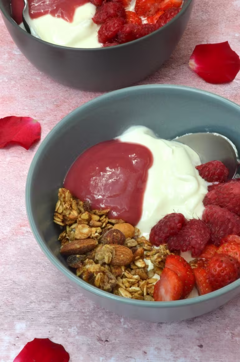 Granola bowl with raspberries, yoghurt and raspberry rose curd.
