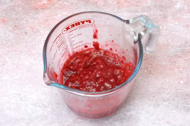Raspberry rose purée in jug.