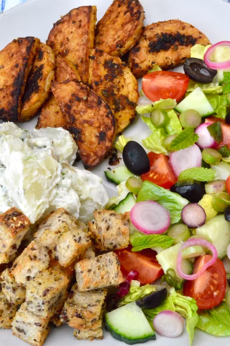 Close up of homemade vegetarian souvlaki salad with fried marinated tempeh.