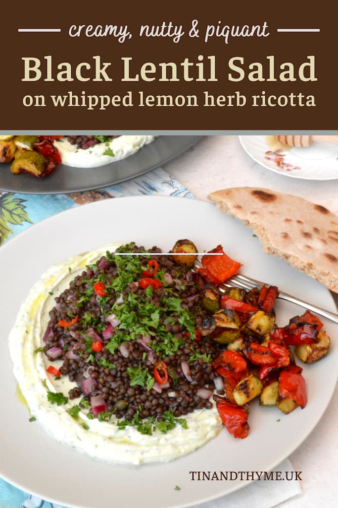 Plate of black lentil salad on herby lemon whipped ricotta with roasted veg.