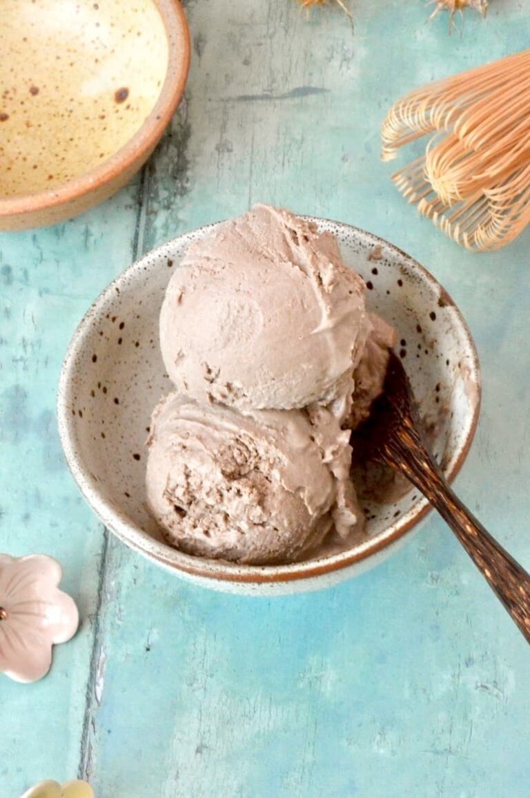Homemade hojicha ice cream scoops in bowl with spoon.