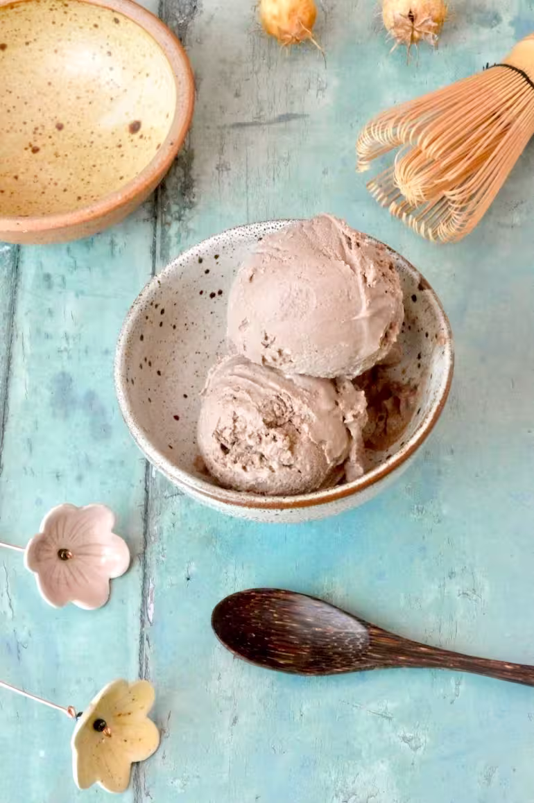Plain homemade hojicha ice cream scoops in bowl.