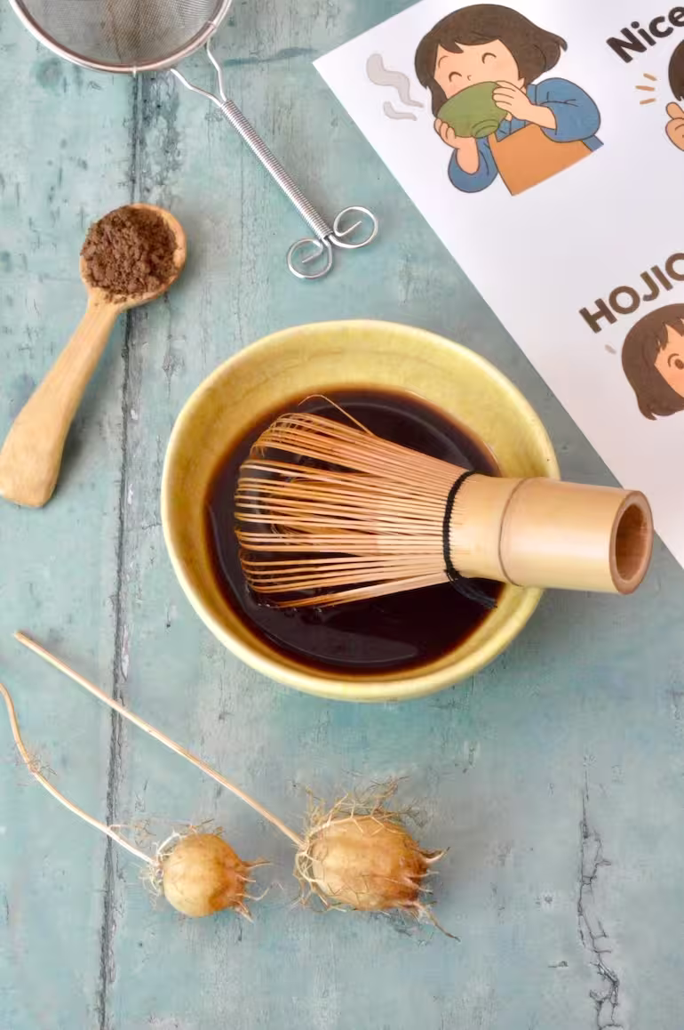 Hojicha tea in bowl with whisk plus spoonful of powder on the side.