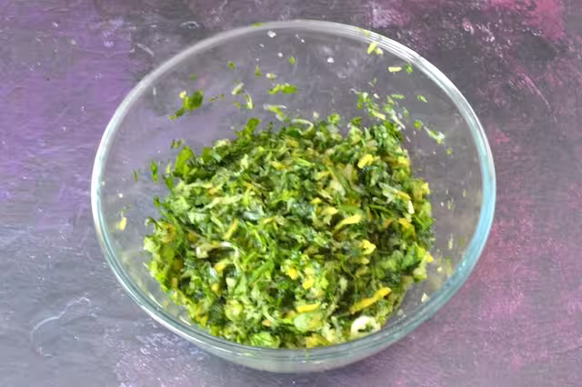Vegetables massaged in bowl to extract juice.