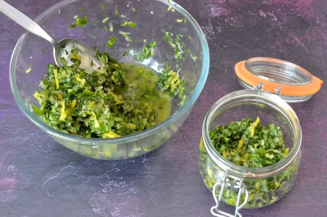 Vegetables and juice in bowl with some transferred to jar.