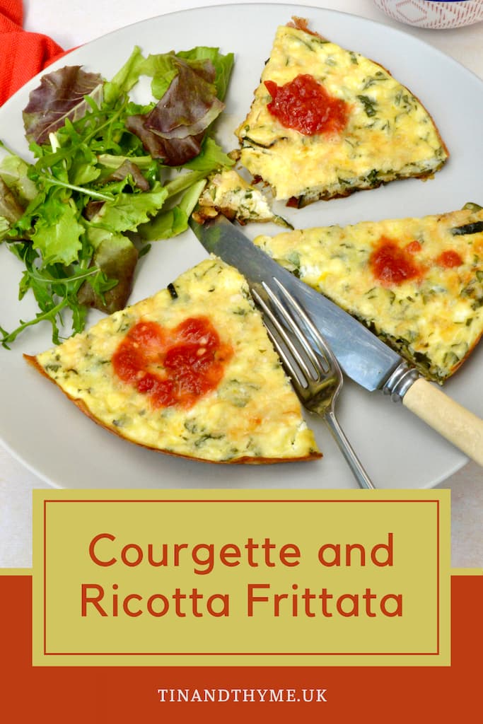 Three slices of courgette and ricotta frittata on plate with knife and fork.