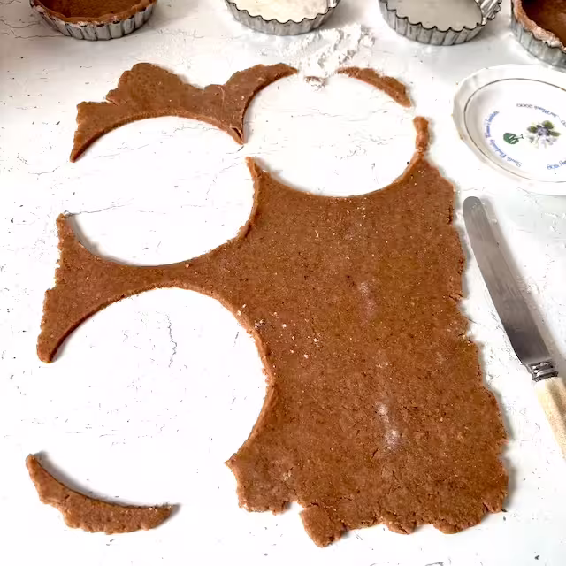 Cutting out pastry circles.