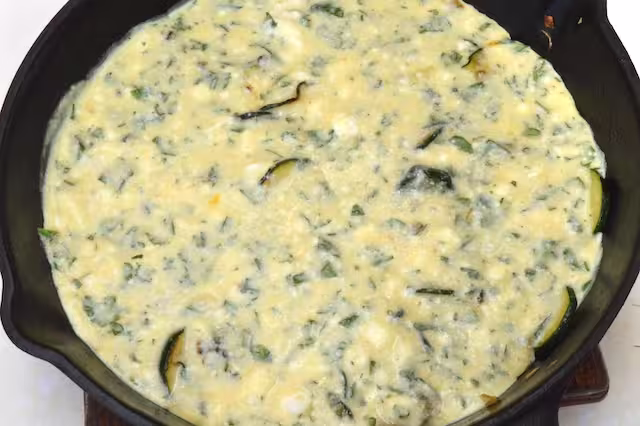Egg mixture poured into cast iron skillet.