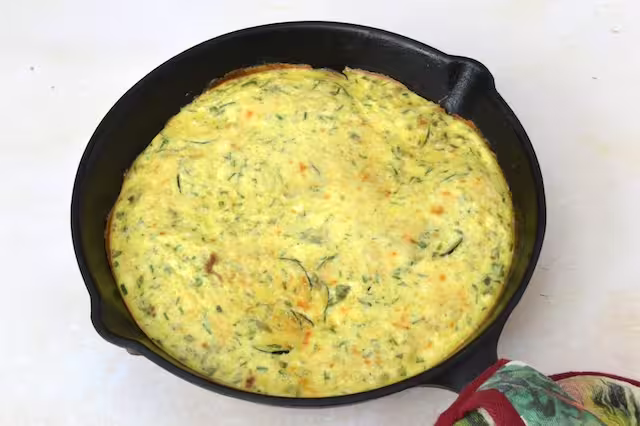 Courgette and ricotta in cast iron pan - ready to slice and serve.