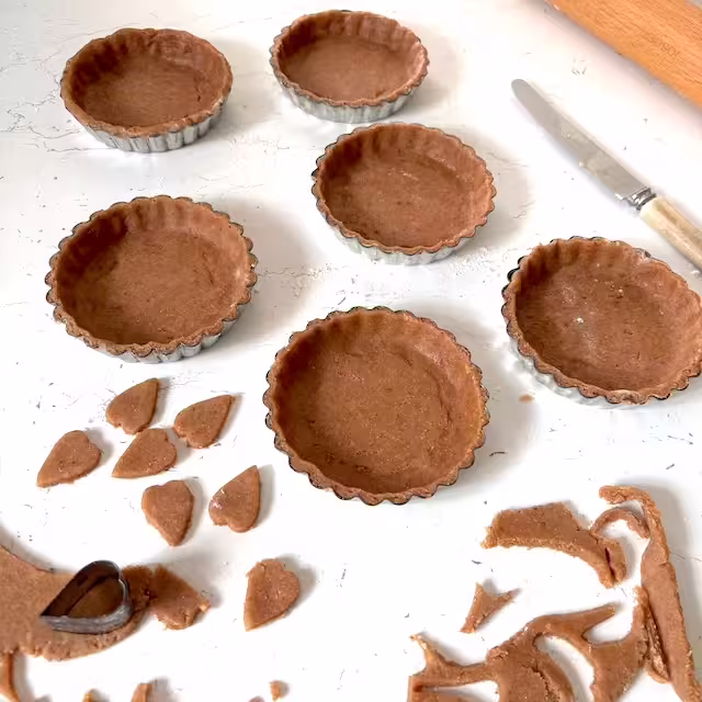 Pastry pressed into tins.